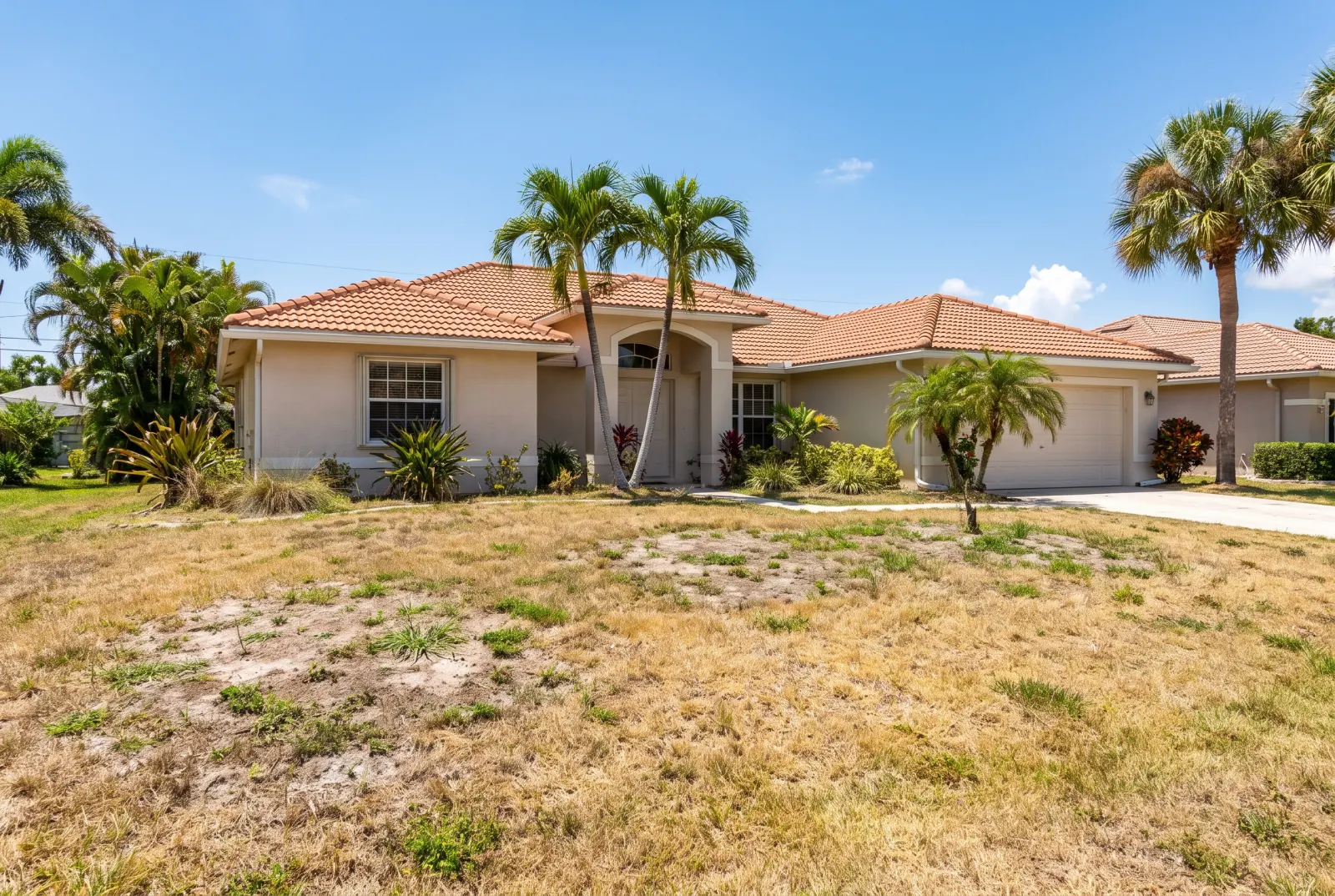 House with a dry, patchy lawn