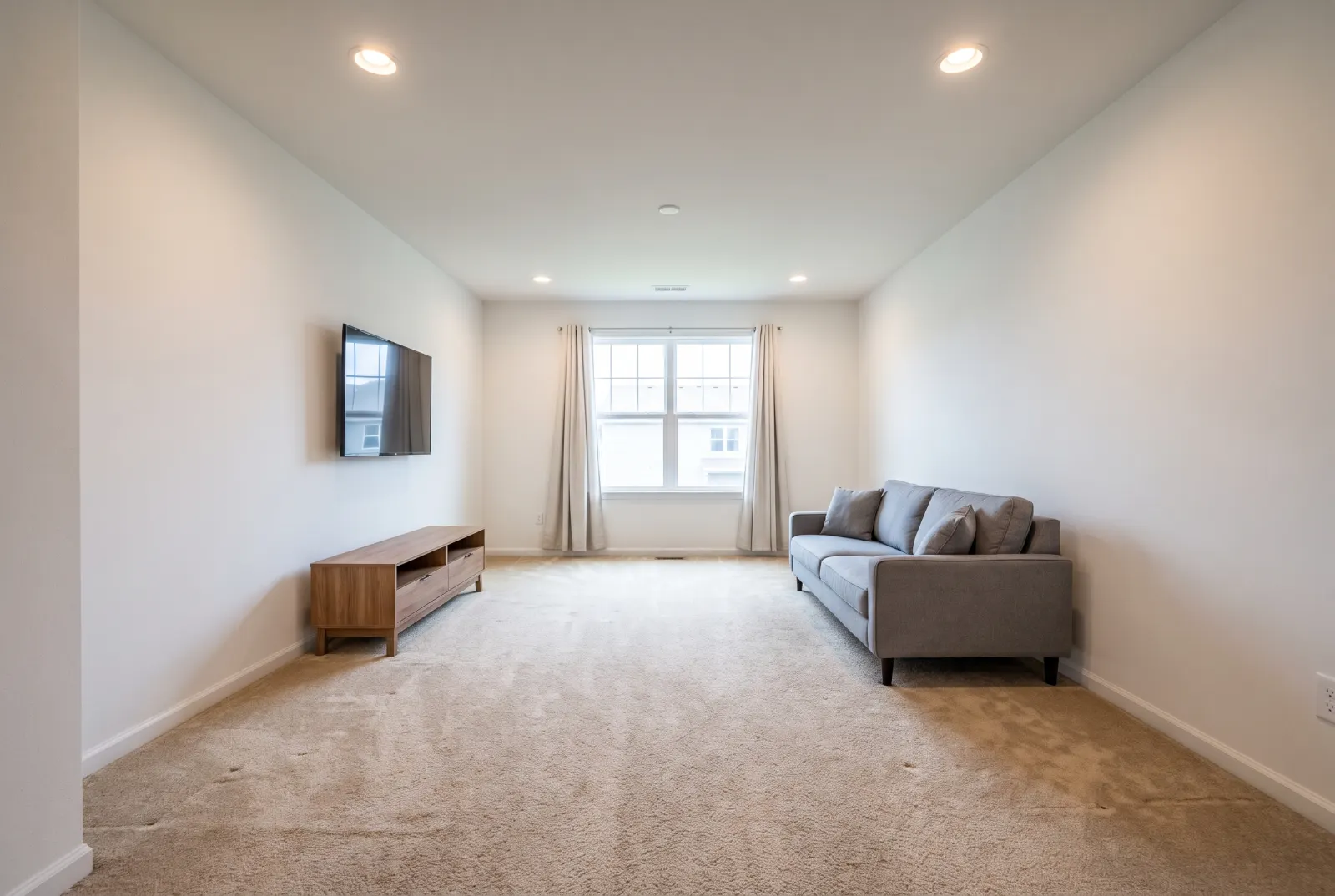 Living room with worn beige carpet