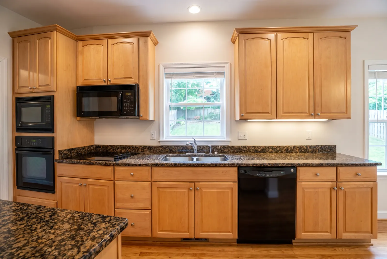 Kitchen with dark granite countertops